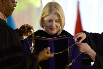 President Zak speaking at a podium